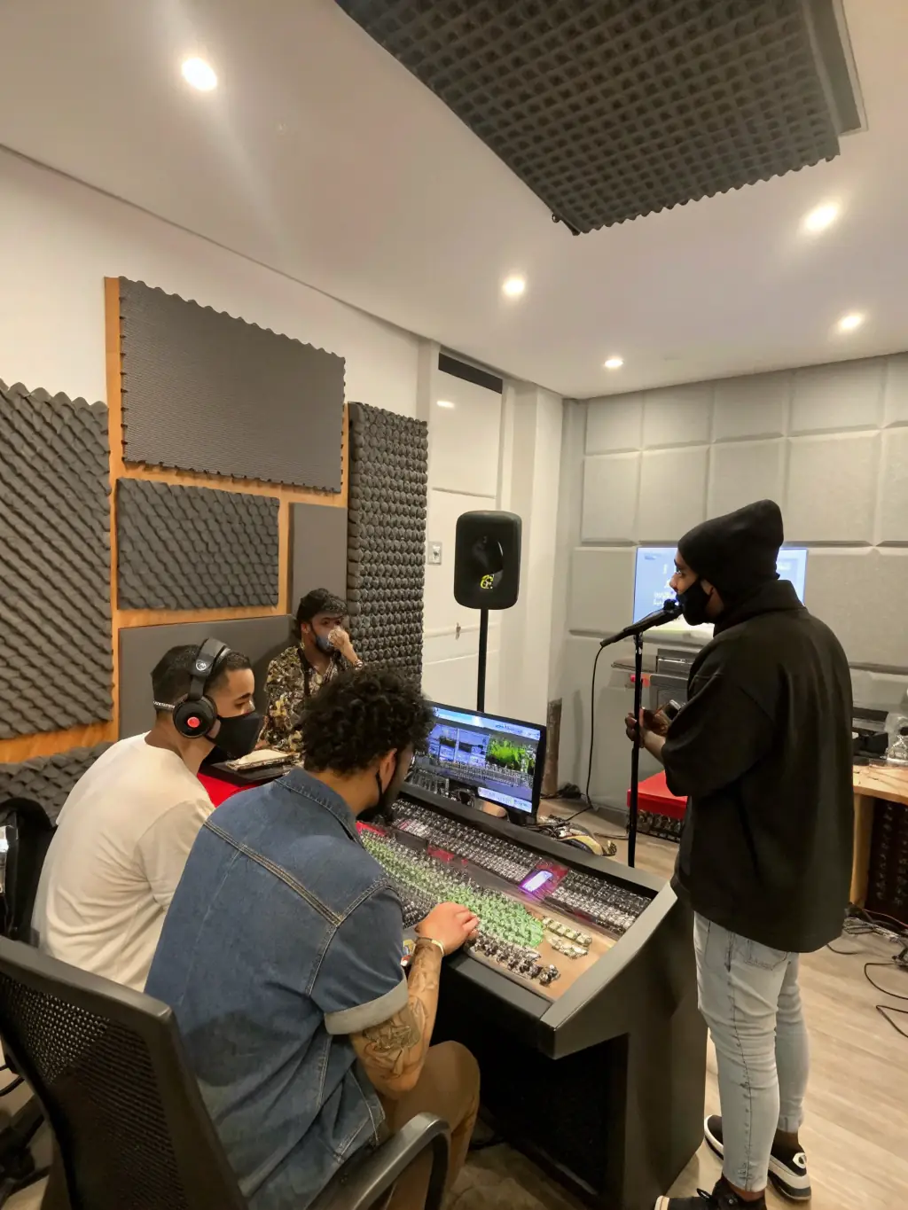 A photo of artists working in a studio, supported by LE SOUS OFF, highlighting the organization's commitment to fostering creativity.